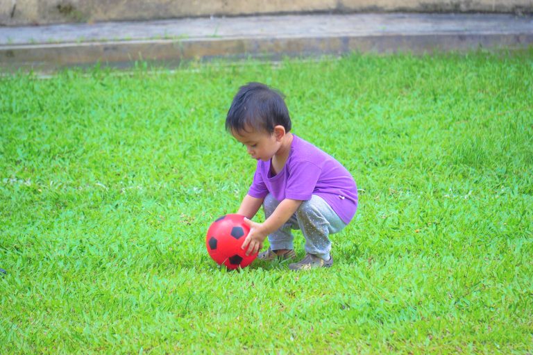 baby-boy-playing-with-ball-field